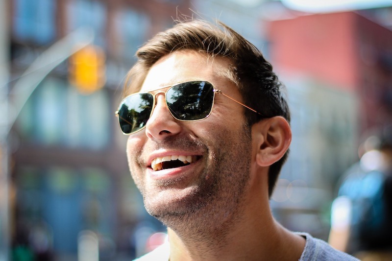 luke bryan outside smiling with clothing and shades on