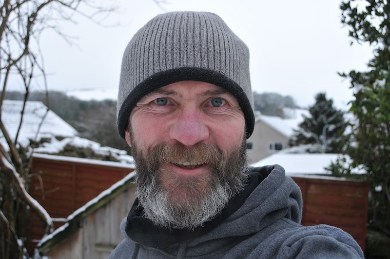 Bill outside on a snowy day smiling with clothing on